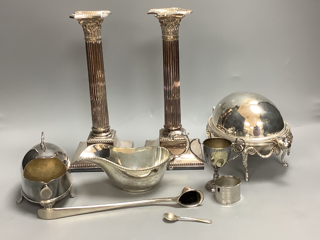 A pair of silver-plated Corinthian column candlesticks, height 28cm a small roll-top breakfast dish, a spoon warmer and five other plated items